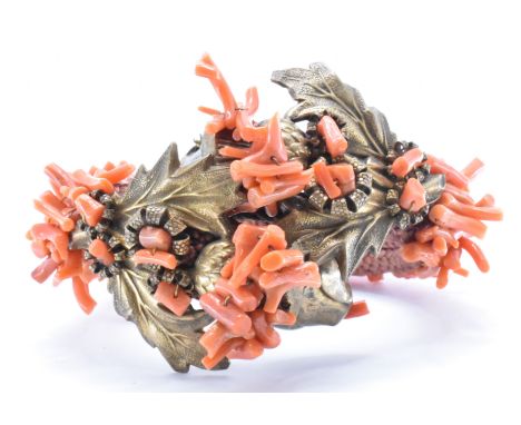 A vintage Frank Hess / Miriam Haskell spezzati coral coil bangle bracelet. The bangle having gold tone filigree and foliate f