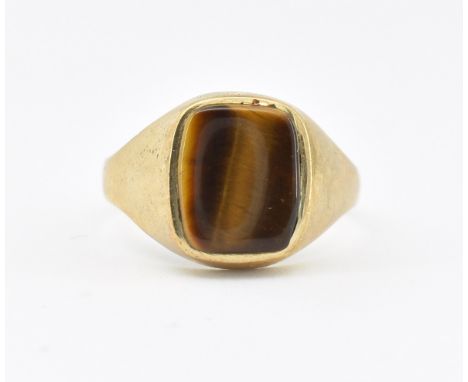 A hallmarked 9ct gold tiger's eye signet ring. The ring set with a rectangular tiger's eye panel to plain tapering shank. Hal