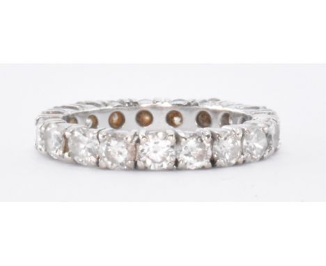 A 20th Century diamond eternity ring. The ring set with nineteen round brilliant cut diamonds. Partially marked 585 to interi