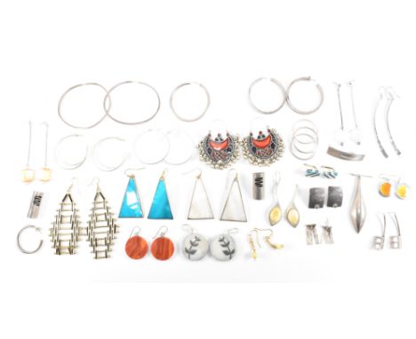 A collection of silver and white metal earrings. The earrings to include hoops, enamel decorated some with gemstones. Measure