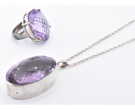 A hallmarked 925 silver and amethyst pendant necklace and ring. The necklace strung with a large chequered oval cut amethyst 