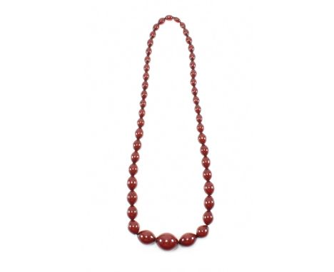 A vintage cherry bakelite beaded necklace strung with 47 graduating beads. Weight 88.7g. Measures 29 inches. Largest bead app