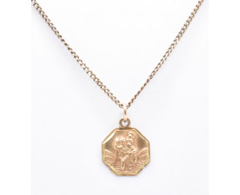 A 9ct gold pendant necklace. The fine link necklace chain having an octagonal St Christopher pendant (hallmarked Birmingham),