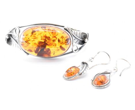 A&nbsp; hallmarked 925 silver and amber bangle bracelet and earring set&nbsp; The bracelet set with an amber cabochon with wi