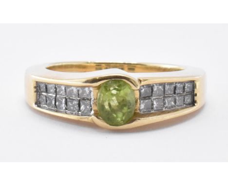 A 14ct gold peridot and diamond ring. The ring being set with an oval cut peridot with ten square cut diamonds to the shoulde