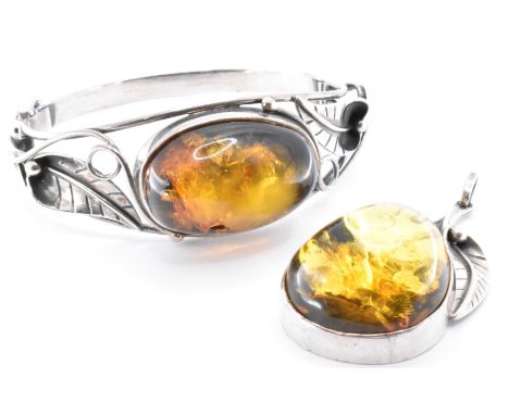 A&nbsp; hallmarked 925 silver and amber bangle bracelet and pendant.&nbsp; The bracelet set with an amber cabochon with with 