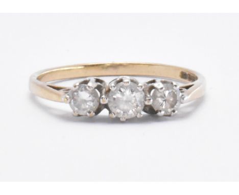 A 9ct gold and white stone ring. The ring set with three graduating round cut white stones in prong settings. Import London 3