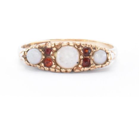 A hallmarked 9ct gold opal and garnet ring. The ring set with three opal cabochon having round cut garnet spacers to scrolled