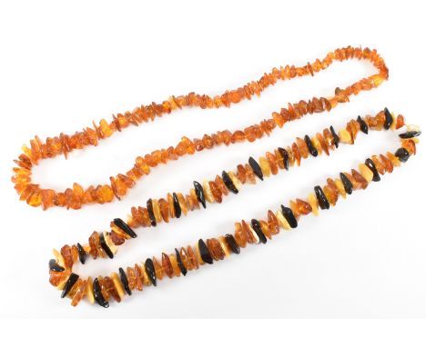 Two vintage amber bead necklaces. A necklace strung with polished amber pieces in a variety of colours on a knotted string. M