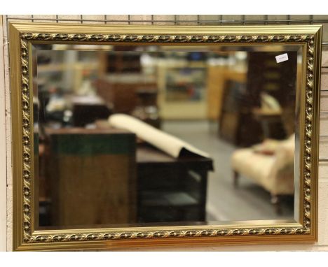 A large modern gilt framed bevelled edge mirror, overall 70 x 100 cm. Not available for in-house P&amp;P, contact Paul O'Hea 