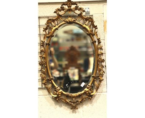 A large 20th century gilt framed oval wall mirror, overall 93 x 56 cm.  Not available for in-house P&amp;P, contact Paul O'He