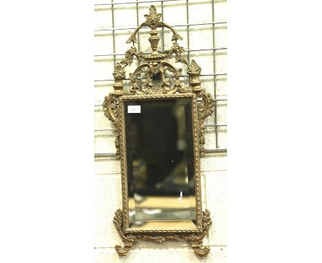 An early 20th century ormolu framed wall mirror with beveled glass, overall 77 x 34 cm.  Not available for in-house P&amp;P, 