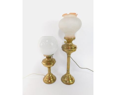A brass fluted column oil lamp, with a frosted glass shade, 66cm high, and a further brass oil lamp, with a white globular gl