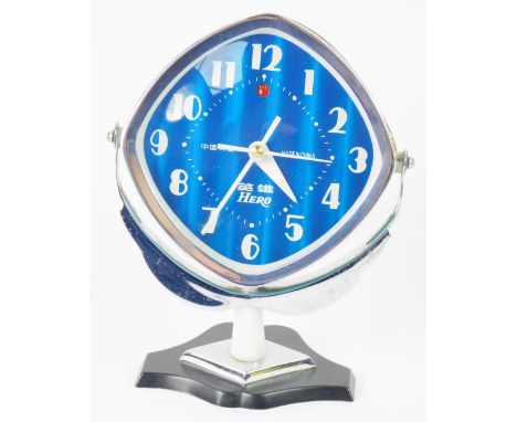 A Chinese c1950 Hero table clock, diamond shaped, blue iridescent dial bearing Arabic numerals, clockwork movement with alarm