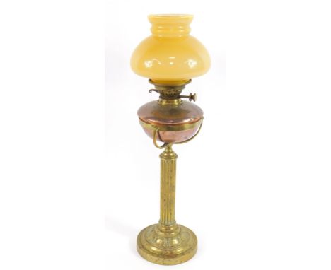A Hinks's duplex no.2 copper and brass oil lamp, with a fluted column and embossed foliate circular base, with a yellow glass