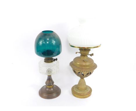 A Zimmermann copper and brass oil lamp, with a clear glass reservoir foliate engraved, and a blue shade, 50cm high, together 
