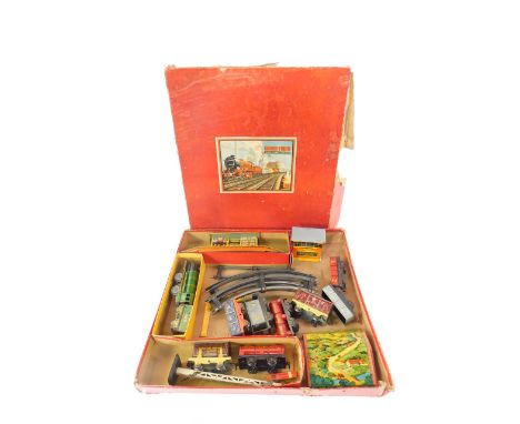 A Chad Valley O gauge train set, tin plate clockwork, with engine and tender, eight wagons, signal, bridge, booking hall, sig