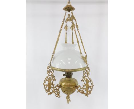 A duplex brass ceiling oil lamp, cast with figures and foliate scrolls, with a white glass shade and ornate hanging chains, 8
