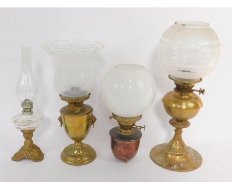 A brass oil lamp, of baluster form with twin lion's head and ring handles, with a white opalescent glass shade, 42cm high, fu
