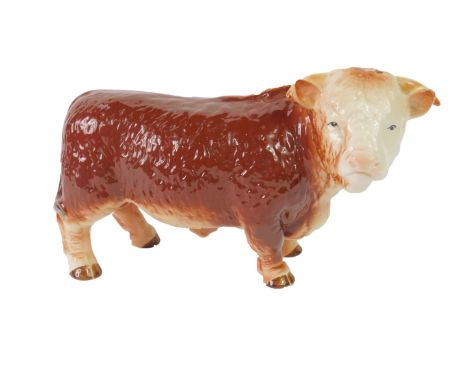 A Melba pottery figure of a bull, printed marks, 26cm long.
