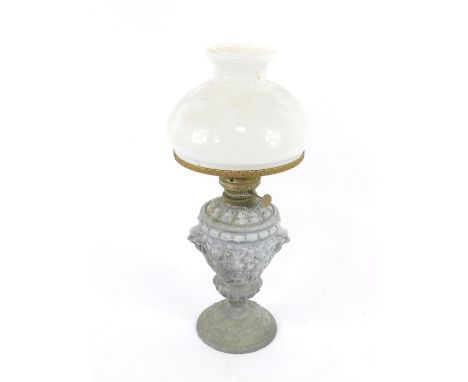 A Zimmerman &amp; Co oil lamp, the base of led finished classical form, embossed with lions mask handles, putti and heraldic 