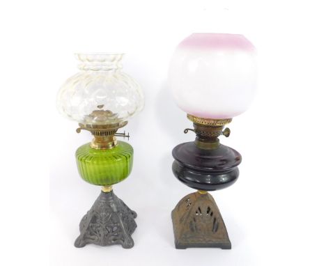 An Art Nouveau style cast iron oil lamp, with a green glass reservoir and clear honeycomb glass shade, 46cm high, and a furth