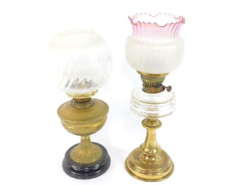 A Youngs' brass oil lamp, with a faceted cut clear glass reservoir, frosted clear to lilac coloured crimped shade, 52cm high,