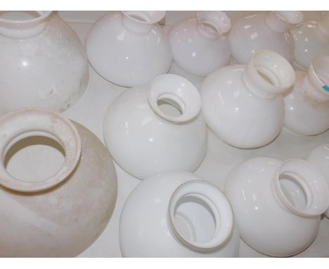Twenty two white glass oil lamp shades, various sizes.
