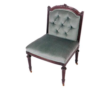 A Victorian mahogany French style armchair, with floral carved crest rail, pale green button back and overstuffed seat, raise