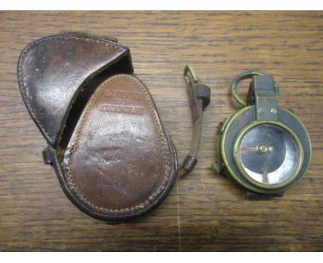 A WWI military issue E Koehn marching compass Verners pattern VIII in leather case serial number 114897, leather case stamped