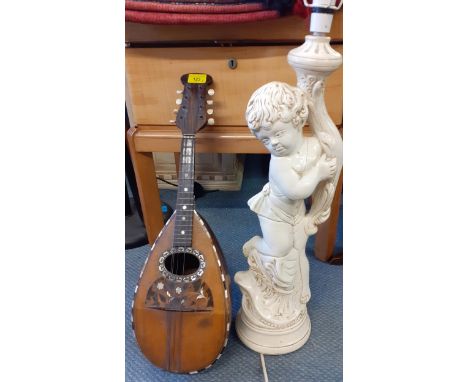 A vintage Strident mandolin together with a mid to late 20th century cream painted lamp of a putti holding a torchLocation: R