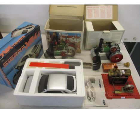 Two boxed Mamod steam engines, an unboxed Mamod steam engine on fixed base, and a remote control model Ford Sierra XR4i Locat