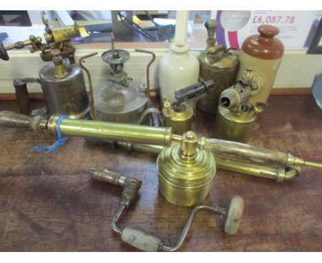 Vintage tools to include four blow lamps, two garden sprayers, a hot-water bottle, a stoneware bottle and a brace 