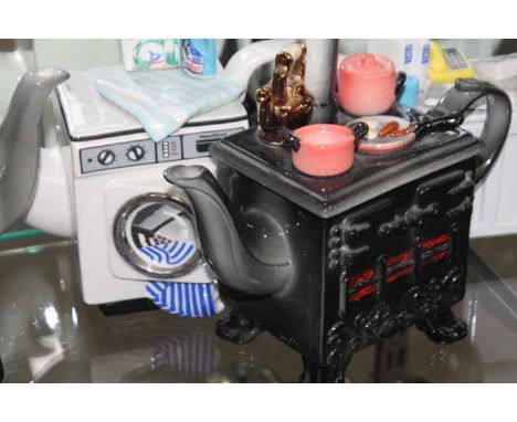 COLLECTION OF CERAMIC NOVELTY TEAPOTS
modelled as a fridge, washing machine, television, oven and desk respectively, the larg