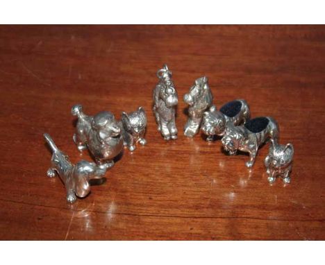 EIGHT SILVER MINIATURE DOG FIGURES
including two pin cushion bulldogs, a poodle key ring etc.