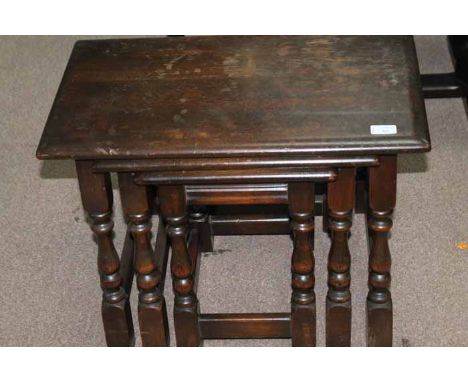 NEST OF THREE ERCOL STYLE MAHOGANY TABLES
comprising one wide principal table and two smaller tables