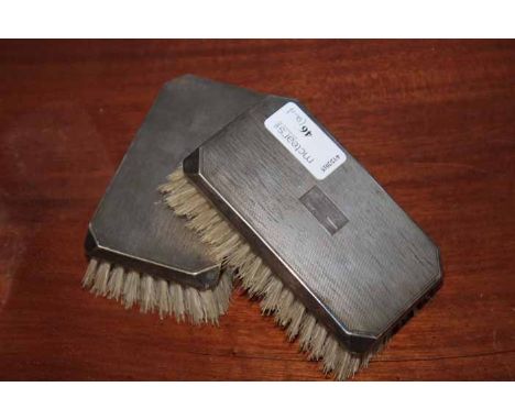 PAIR OF SILVER CLOTHES BRUSHES
maker F H Adams & Holman, Birmingham 1921, of rectangular form with attractive engine turned t