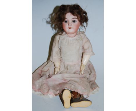 A Max Handwerck bisque head doll, having rolling brown eyes and open mouth with four top teeth showing, having jointed compos