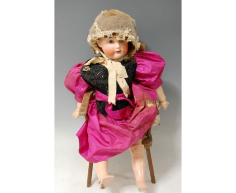 A Simon &amp; Halbig for Kammer &amp; Reinhardt bisque head doll, having fixed blue eyes, open mouth with four top teeth show