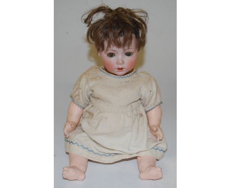 A Simon & Halbig bisque head doll, having fixed brown eyes and open mouth with two top teeth showing, having bent limbed comp