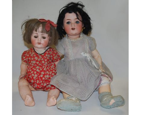 A Max Handwerck Bébé Elite bisque head doll, having rolling brown eyes, open mouth with four top teeth showing, and bent limb