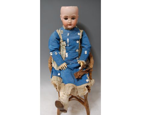A large Simon & Halbig German bisque head doll, number 1078, having rolling blue eyes, open mouth with four top teeth showing