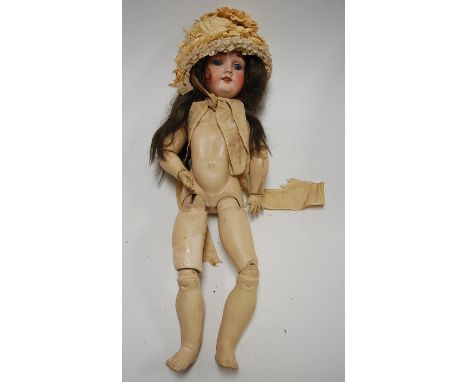 A Max Handwerck bisque head doll, having fixed blue eyes and open mouth with four top teeth showing, with painted wooden and 