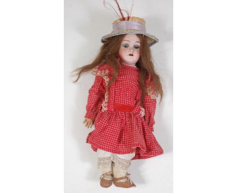 A Heinrich Handwerck for Simon &amp; Halbig bisque head doll, having rolling blue eyes and open mouth with two top teeth show