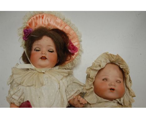 An Armand Marseille bisque head doll, having rolling blue eyes and open mouth with two top teeth showing, with bent limbed co