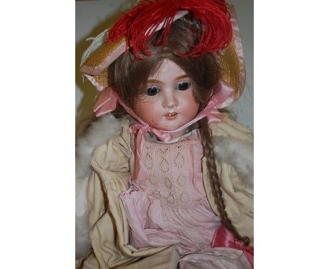 A large Max Handwerck bisque head doll, having rolling brown eyes, open mouth with four top teeth showing, and jointed compos