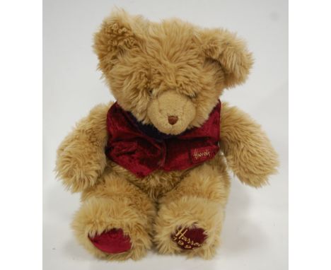 A Harrod's year bear for 1996, light brown mohair, wearing a maroon waistcoat with purple bow-tie, having glass eyes, h.42cm;