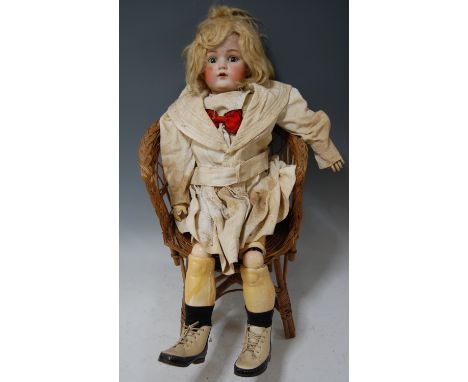 A Christian Friedrich Kling bisque head doll, having rolling blue eyes open mouth with two top teeth showing, with jointed co