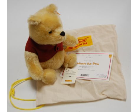 A Steiff Danbury Mint Winnie the Pooh bear , in honey mohair, with glass eyes and jointed body, having button to ear, numbere