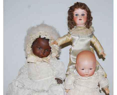 An Armand Marseille black bisque head doll, having rolling brown eyes and painted mouth, with bent limbed composition body, m